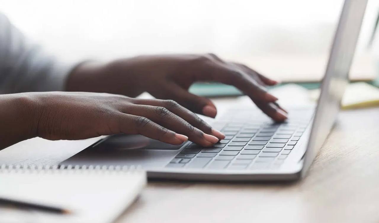 A bid manager reviewing public-sector tenders on a laptop